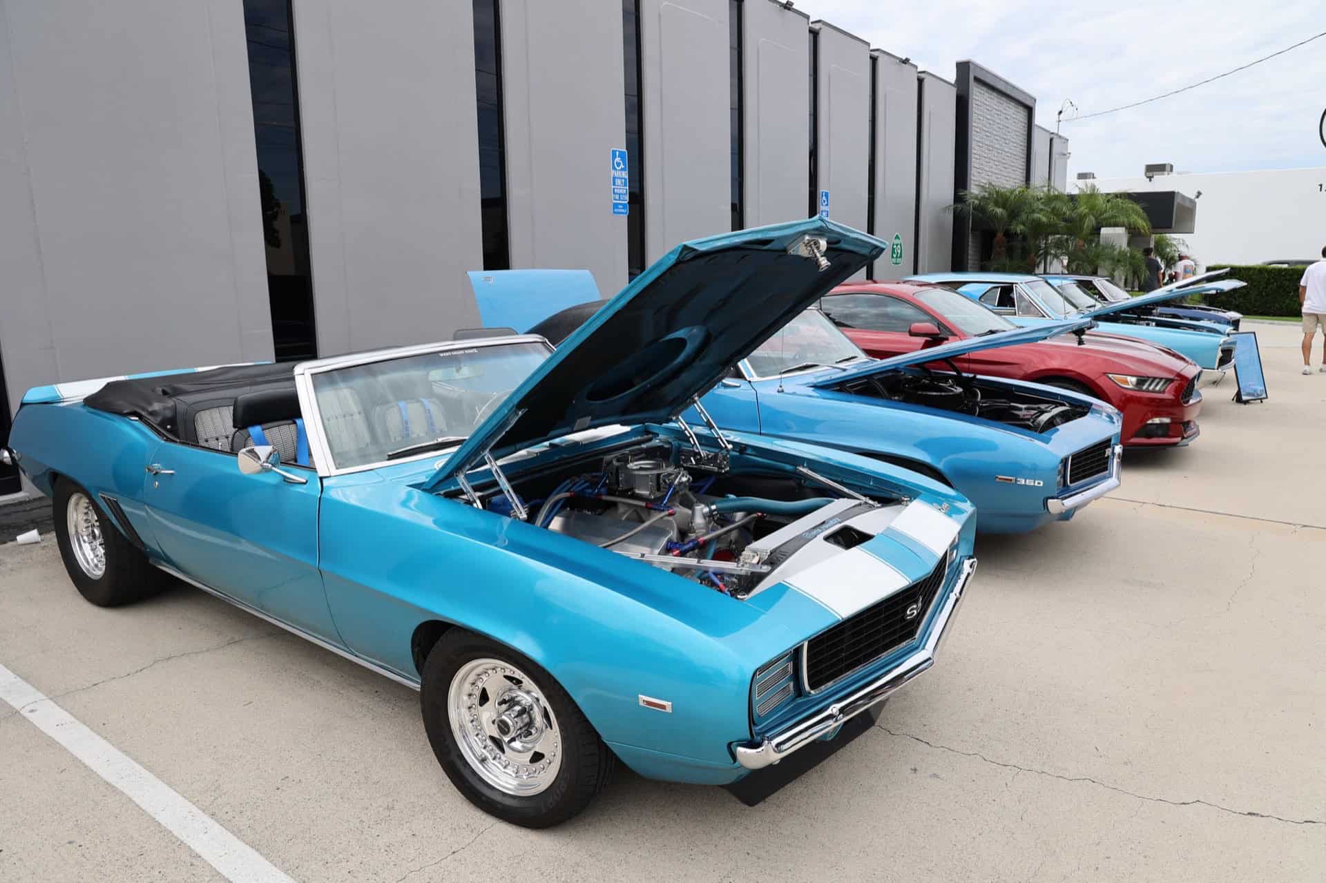 Vintage blue muscle car with open hood showcasing engine at Highway 39 Event Center.