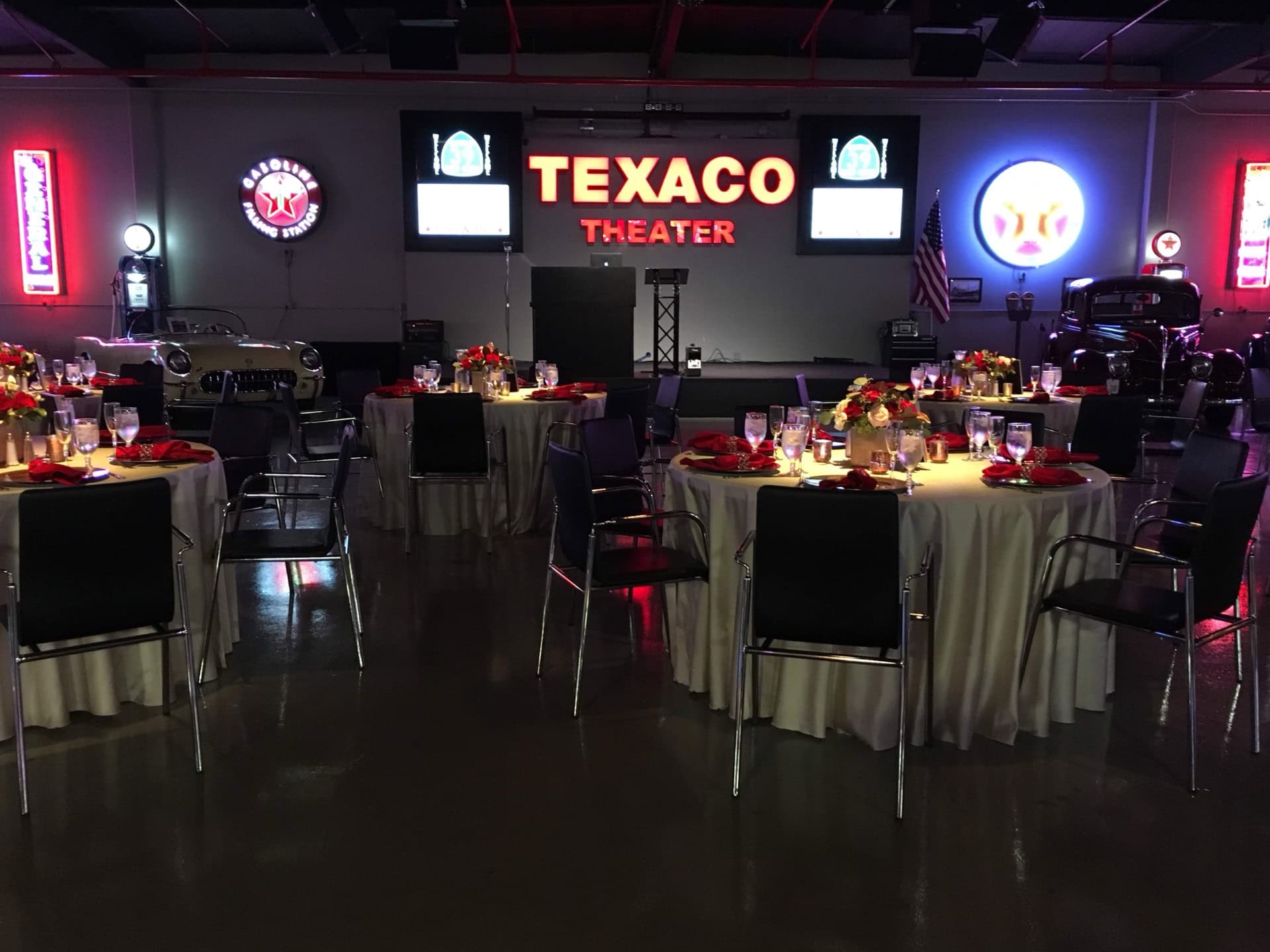 Event space at Highway 39 Event Center with round tables and stage setup.